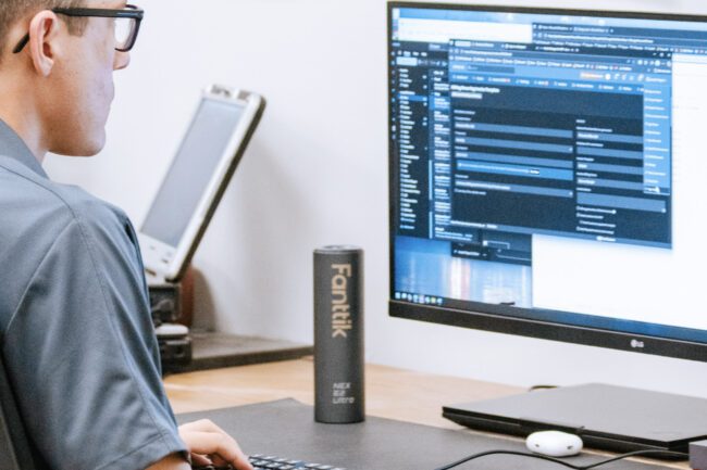 3CTech technician monitoring IT systems and cybersecurity dashboards